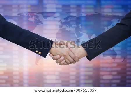 business women with suit clothes uniform handshake on map on blurred business board fro deal concept Royalty-Free Stock Photo #307515359
