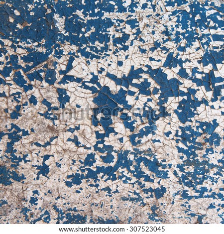 macro isolated fragment of the old dilapidated wall painted white and blue