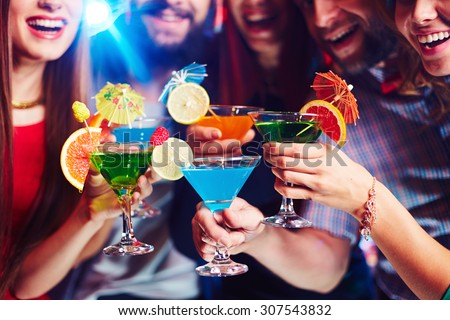 Young people drinking cocktails at nightclub Royalty-Free Stock Photo #307543832
