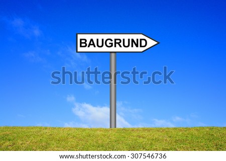 Street Sign showing Plot in german language in front of blue sky on green grass