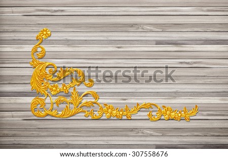 Pattern of  gold flower carve on wood background