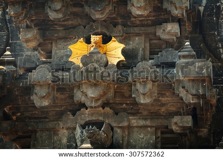 Intricately carved facade of Goa Lawah Bat Cave Temple, including dramatic, stylized sculptures of bats, in Bali, Indonesia.