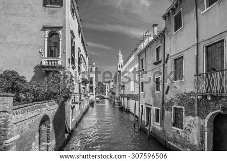 Venetian canal Rio de la Pleto. Old walls with balcony and architecturical elements. Venice, Veneto, Italy. Black and white photography.