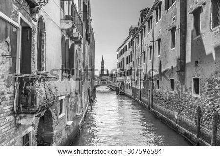 Venetian canal Rio de la Pleto. Old walls with balcony and architecturical elements. Venice, Veneto, Italy. Black and white photography.