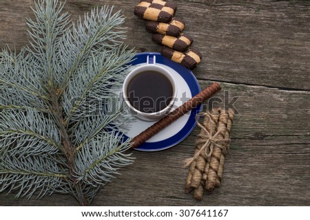 still life from a fir-tree branch, cookies and black coffee