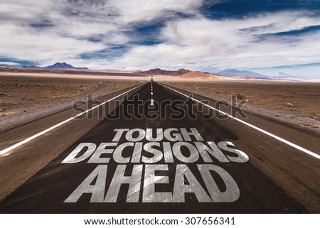 Tough Decisions Ahead written on desert road