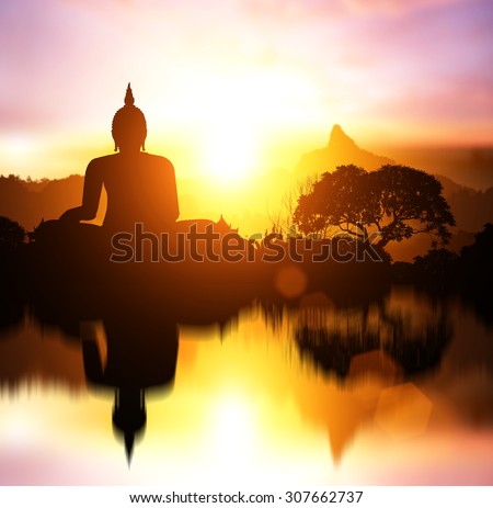 Water Reflection Silhouette of Buddha on  sunset with mountain behind.end of Buddhist Lent