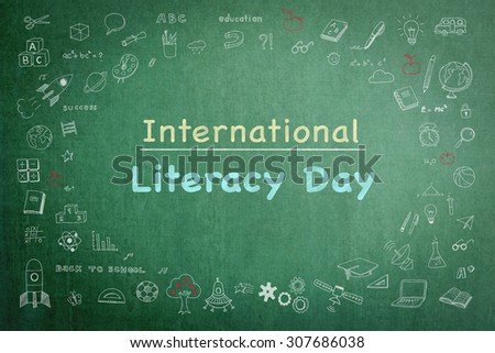 International literacy day greeting on black chalkboard with doodle  Royalty-Free Stock Photo #307686038