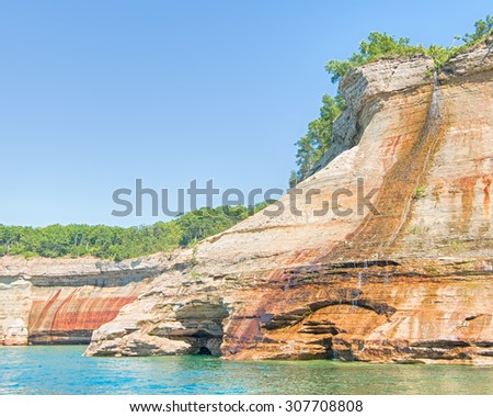 Bridalveil Falls in Pictured Rocks National Lakeshore, near Munising, Michigan. Mineral seepage creates the colors: Red/orange are iron, green/ blue are copper, black is manganese, and white is lime.