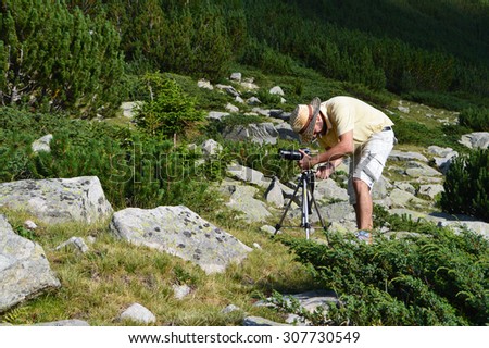 Young Photographer Shooting in The Wild Nature