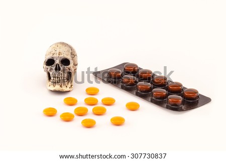 Human skull and drugs on isolated white background.