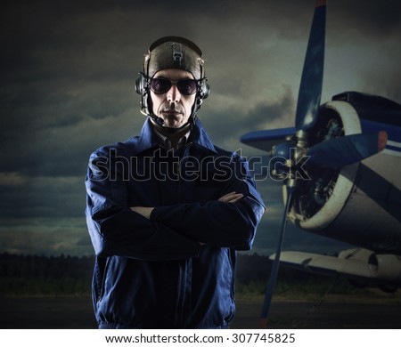 The pilot of the plane on the background.