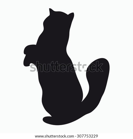 Black silhouette of a large adult cat isolated on a light background. Cat standing on his hind legs and reaches up.