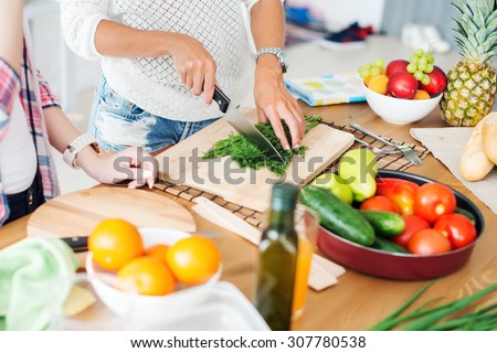 Gorgeous young Women preparing dinner in a kitchen concept cooking, culinary, healthy lifestyle Royalty-Free Stock Photo #307780538