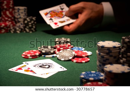 The winning hand blackjack casino card game showing chips on green felt background