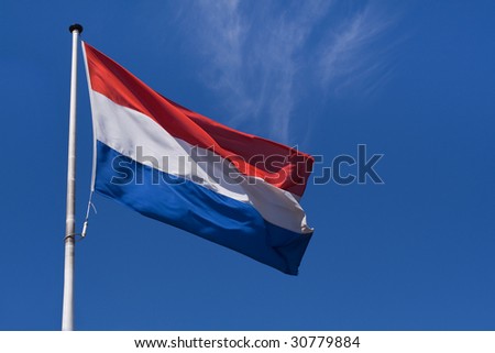 Waving flag of The Netherlands against the clear blue sky