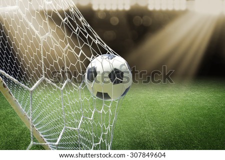 soccer ball in goal with spotlight Royalty-Free Stock Photo #307849604