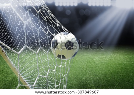 soccer ball in goal with spotlight Royalty-Free Stock Photo #307849607