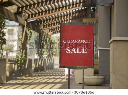 Clearance sale sign outside shop in outdoor upscale shopping mall