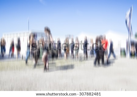 Large crowd of people watching rock concert, festival spring summer time , blurred background