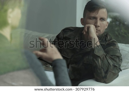 Despair soldier receiving psychological advice during therapy Royalty-Free Stock Photo #307929776
