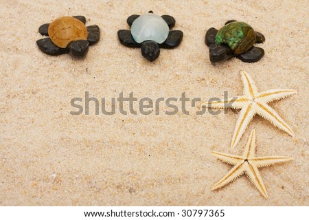 Three brown turtles with colourful shells and starfishes sitting on a sand background, three turtles