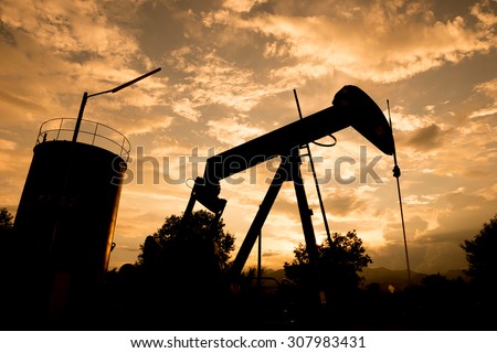old pumpjack pumping crude oil from oil well