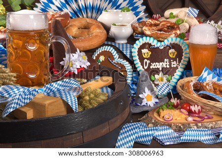 All typical German Bavarian symbols in one picture. Gingerbread heart, soft pretzels, Bavarian veal sausage and beer.