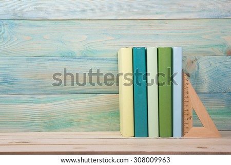 Back to school. Stack of colorful books on wooden table. Composition with vintage old hardback books, diary on wooden deck table. Books stacking. Copy Space. Education background.