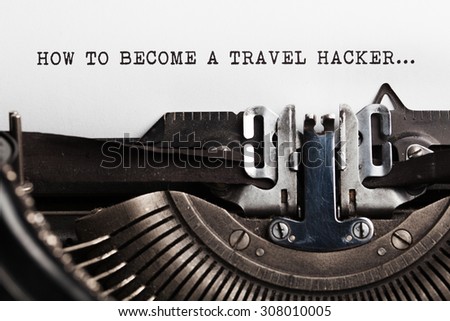 Become a Travel Hacker sign with written by a typewriter 