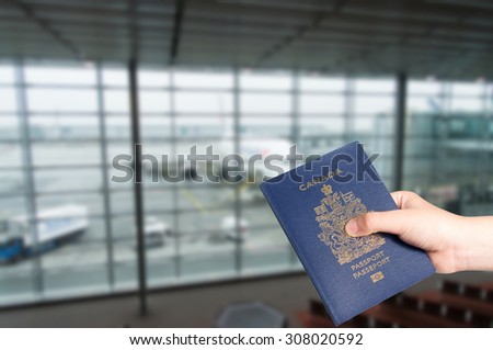 Young Asian boy handing Canadian passport with airplane in background, boarding concept