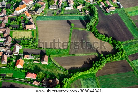 Bird Eye View of the Countryside with Village and Fields of Crops. Aerial Views. Royalty-Free Stock Photo #308044361