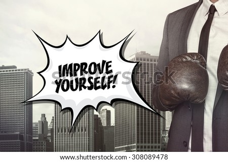 Improve yourself text with businessman wearing boxing gloves on cityscape background