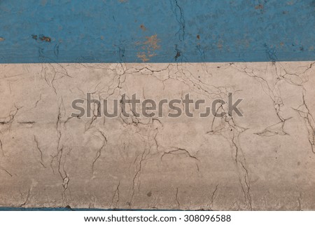 Cracked paint on the floor, white and blue