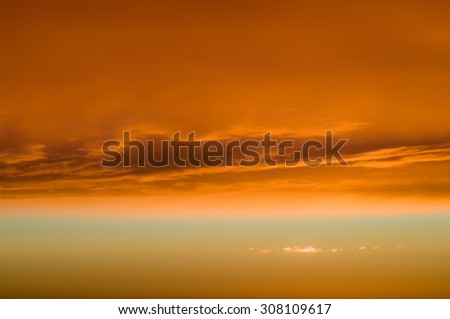 Fiery orange clouds and dramatic golden sky, sunset background