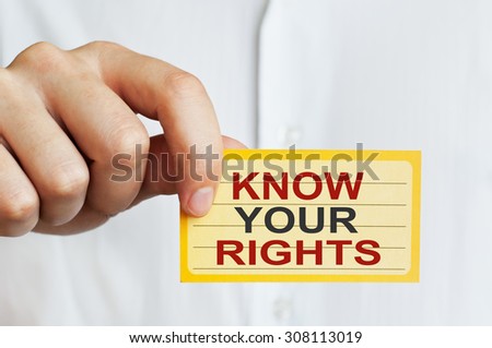 Know Your Rights. Man holding a card with a message text written on it