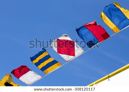 Nautical flags against the blue sky