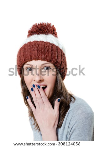 Amazed pretty young girl in winter knitted hat isolated picture