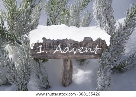 Wooden Christmas Sign With Snow And Fir Tree Branch In The Snowy Forest. German Text 1 Advent Means Christmas Time For Seasons Greetings Or Christmas Greetings. Christmas Atmosphere.