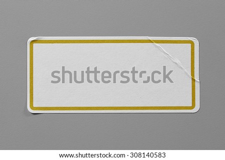 Label Adhesive Close Up on Grey Background with Real Shadow. Top View of Adhesive Paper Tag with Yellow Border. Stickers with Copy Space for Text or Image