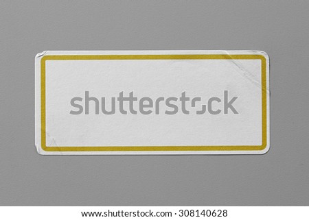 Label Adhesive Close Up on Grey Background with Real Shadow. Top View of Adhesive Paper Tag with Yellow Border. Stickers with Copy Space for Text or Image
