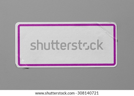 Label Adhesive Close Up on Grey Background with Real Shadow. Top View of Adhesive Paper Tag with Pink Border. Stickers with Copy Space for Text or Image