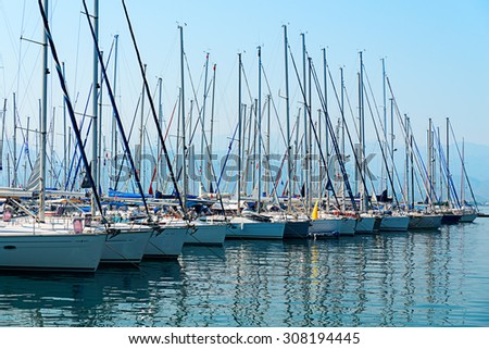 Image of pristine yachts and boats moored on the calm blue seas of the turkish riviera in mid summer