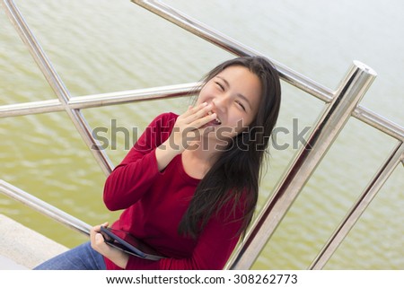 Woman Use Tablet for Relaxation on the Bridge