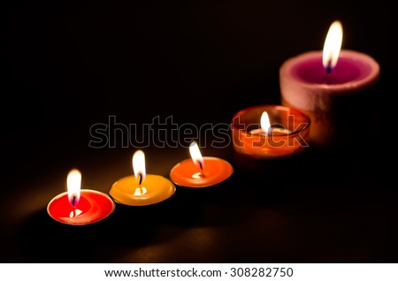 Rows of burning colorful candles - candle light