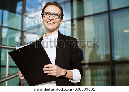 Happy Business woman, successful business lady portrait, manager holding documents.