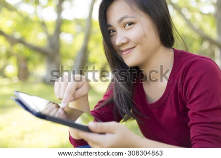 Woman Use Tablet for Relaxation at Park