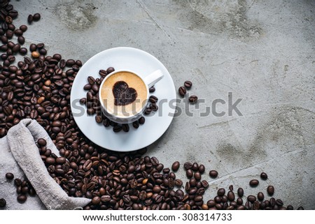 Cup of coffee with bag of roasted coffee beans