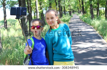 Couple taking selfie photo with smart phone children boy girl friendship