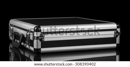 Silver steel suitcase on black background